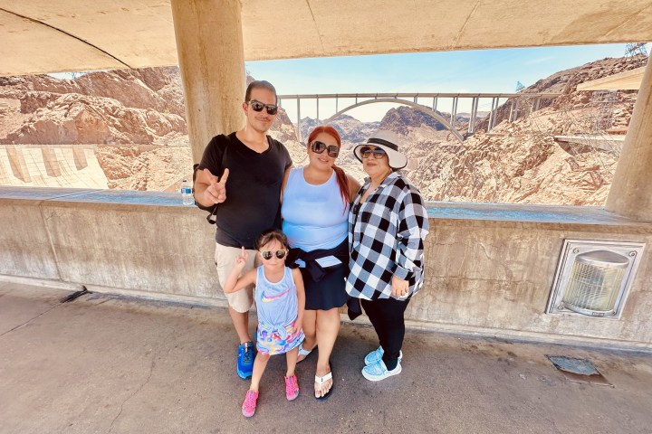 a little girl standing in front of a building