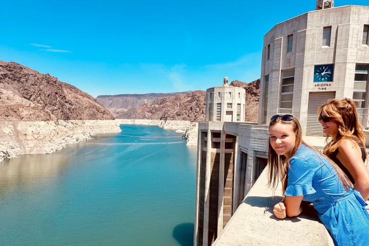 a woman standing in front of water