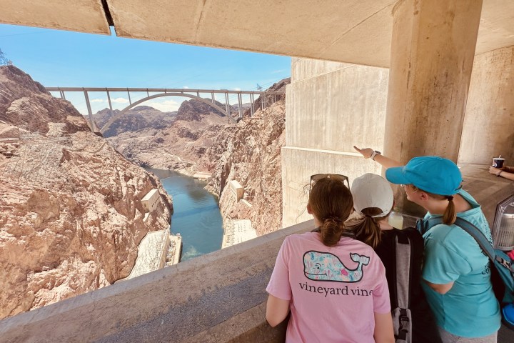 a group of people standing in front of a brick building